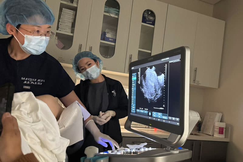 doctors at harvest surrogacy performing ultrasound